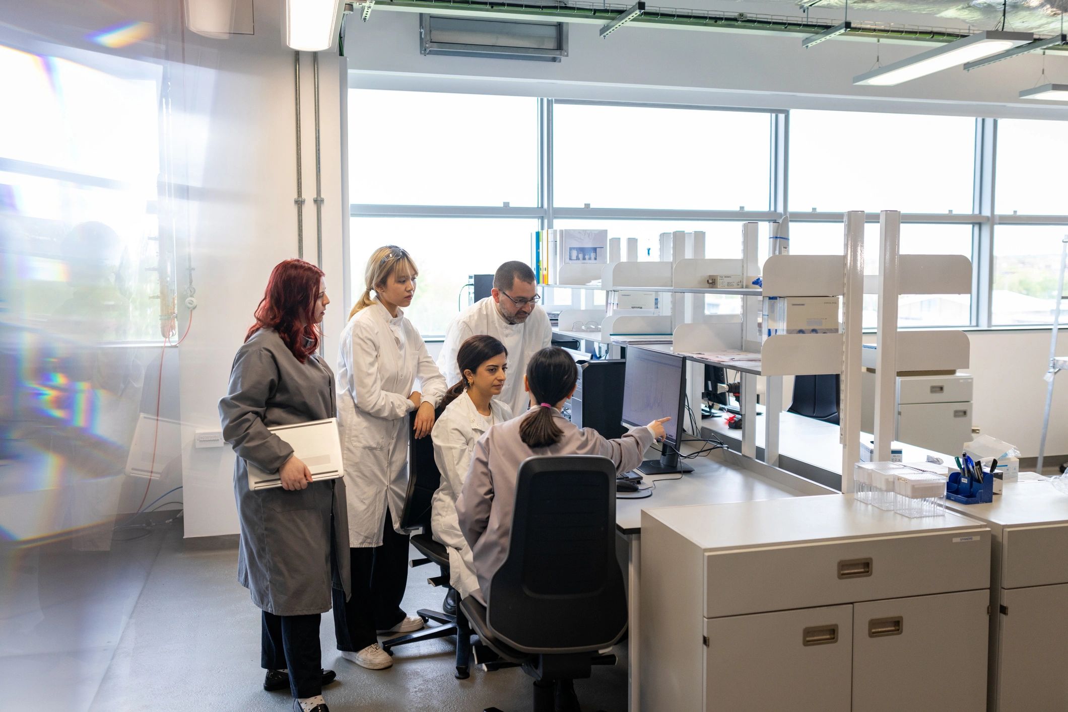 Scientists reviewing research together at a computer